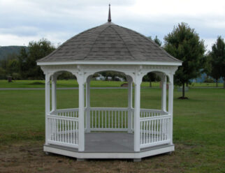 12 Foot White Vinyl Gazebo With Black Shingles On Bell Roof In A Backyard