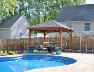 12 x 12 Traditional Wood Pavilion With Brown Stain, Hip Roof and Asphalt Shingles In Backyard Pool Setting