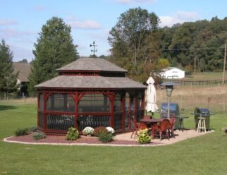 14 x 20 Oval Gazebo, Baroque Style Shown with Mahogany stain, vinyl lite window and door package, Pagoda roof, weathervane and 30 year architectural shingles