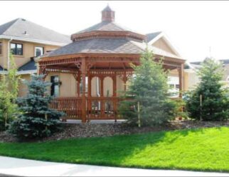 20′ Octagon Gazebo New England Style Shown with Canyon Brown stain, Turned posts, Victorian braces, Pagoda roof, Cupola, Benches and 30 year architectural shingles.