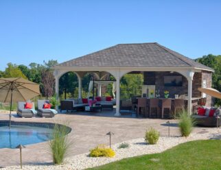 22’ x 24’ Grand Estate White Vinyl Pavilion With Asphalt Shingles In A Backyard Pool Patio