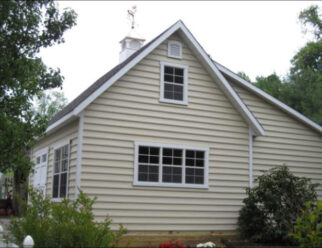 Two Story Backyard Barn With Beige Vinyl Siding