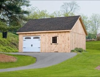 Two Story Detached Wood Garage With White Vinyl Garage Door