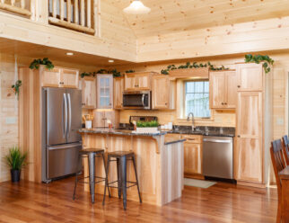 Kitchen with Quartz Counter Tops and Hickory Flat-Panel Tiered Island in the 28×52 Mountaineer Deluxe Cabin Interior