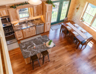 Mountaineer Deluxe Cabin Interior - Kitchen with Quartz Counter Tops and Hickory Flat-Panel Tiered Island