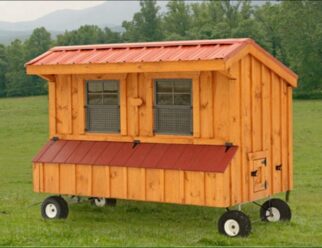 Natural wood Amish-built 4'x8' tractor Chicken Coop with wheels, and red metal overhang roof