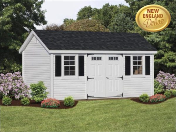 White vinyl shed surrounded by flowers in backyard