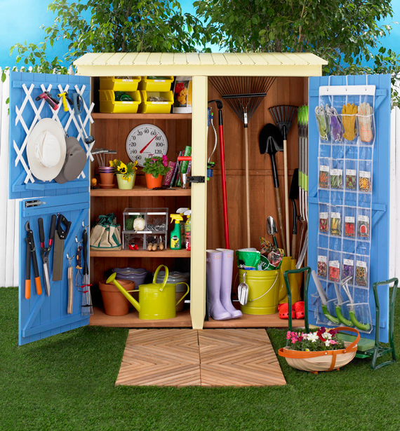 blue shed with open doors, items stored on back of the door