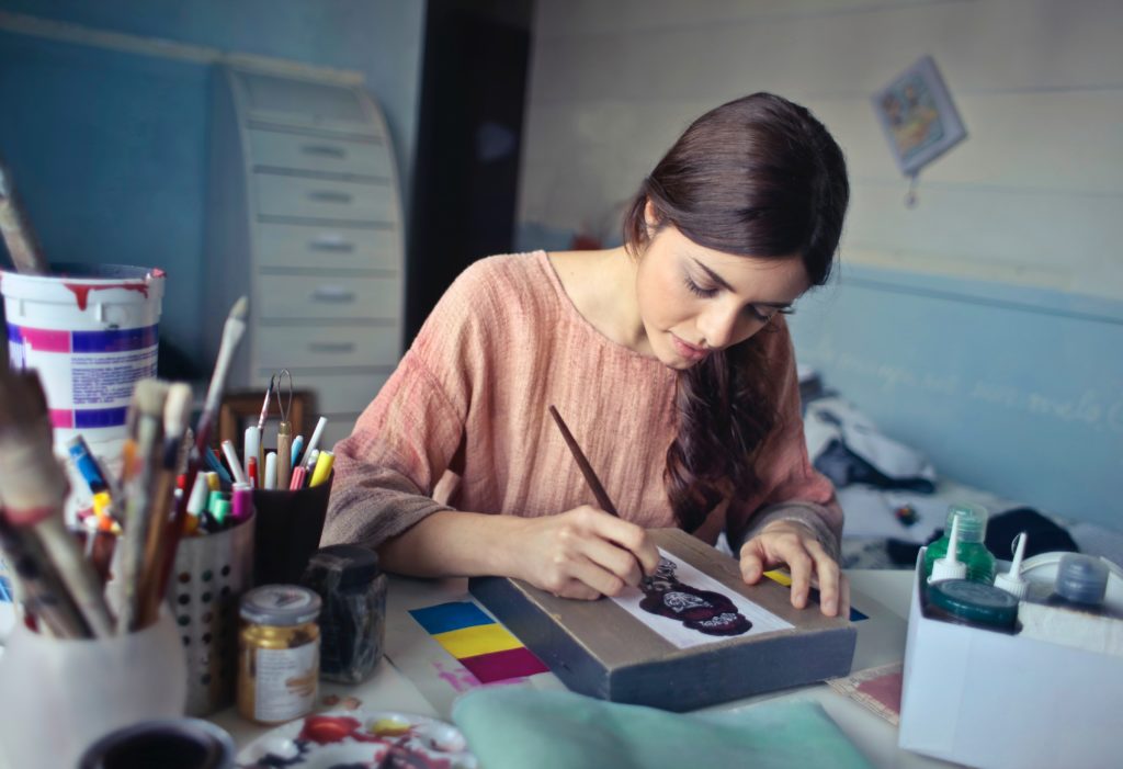 women working on an art project in her studio