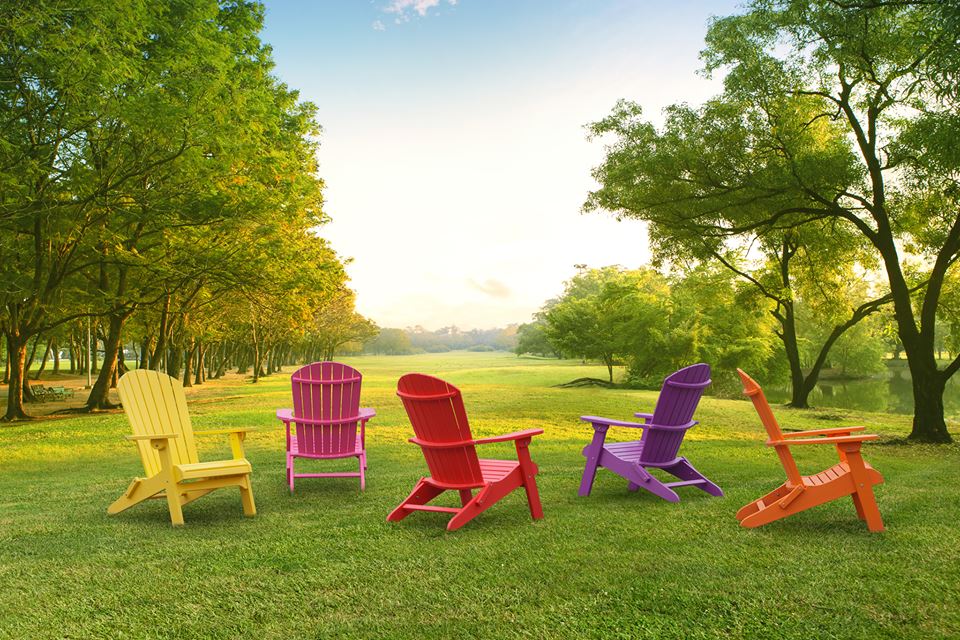 bright colorful adirondack chairs in backyard
