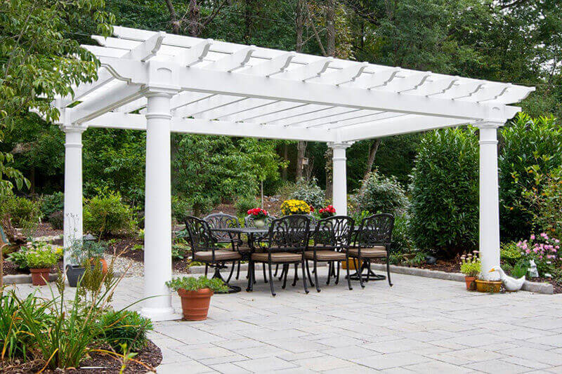 White vinyl pergola covering dining table on patio