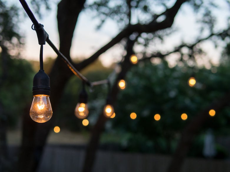 String lights lit during a brisk fall evening sunset.