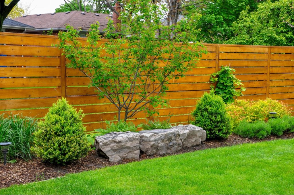 A picture of a wooden fence outlining a backyard.