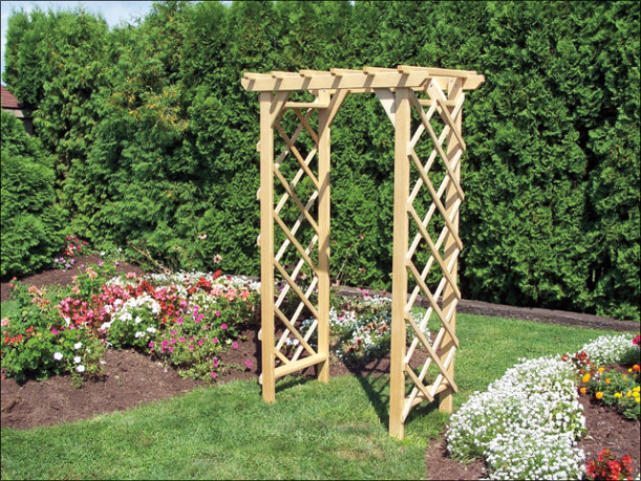 Wooden arbor in the muffle of a garden.