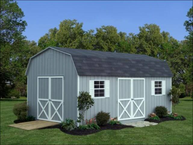 Grey Dutch Barn Shed With White Trim Accent Around Door and White Shutters Around Two Windows