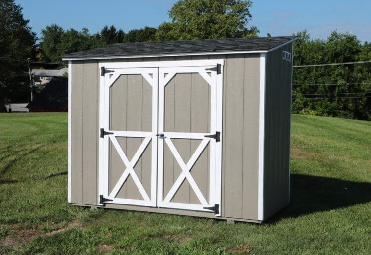 Wooden Gray Mini Barn Shed With White Trim Door