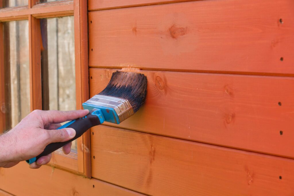 Painting shed with new coat and color.