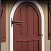Brown arched door with white trim