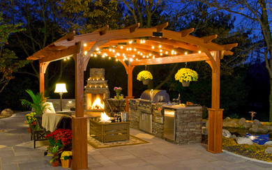 Wooden Outdoor Pergola With Hanging Lights Over A Fireplace With Outdoor Furniture