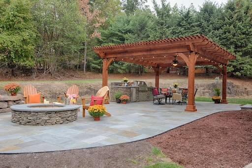 Wood pergola with outdoor seating and fire pit.