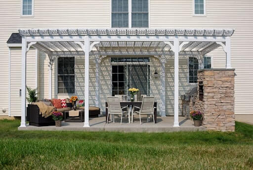 White vinyl pergola with an outdoor kitchen.