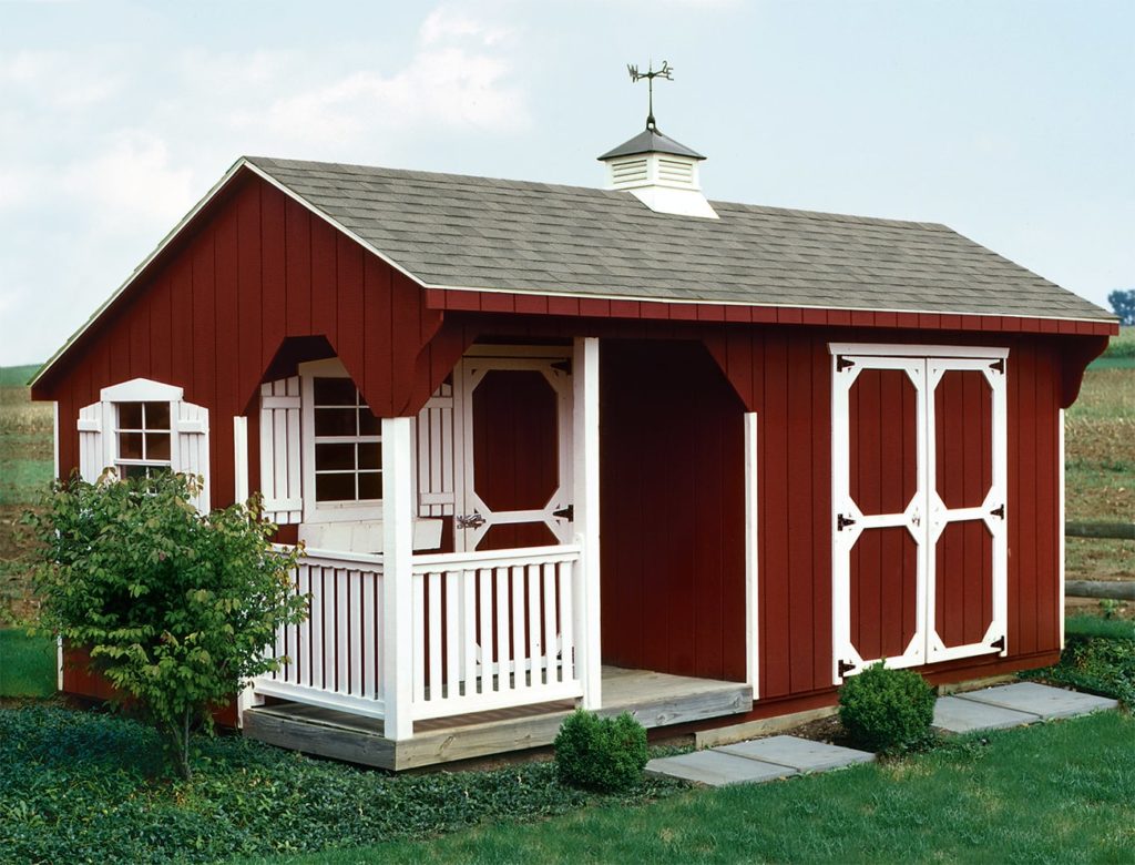Red and white shed with porch.