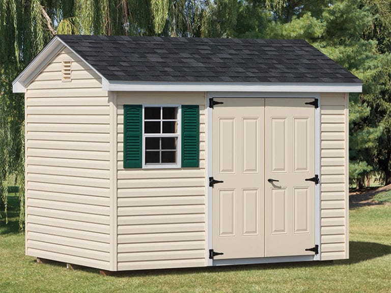 a cottage style shed with a double entrance door and one window with green shutters.