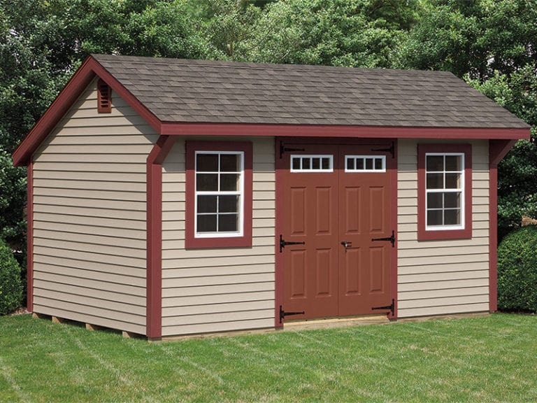 a quaker shed with red trim and doors and two windows.