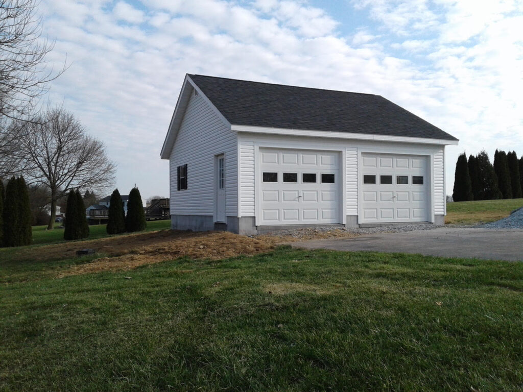 a white garage with two white garage doors. 