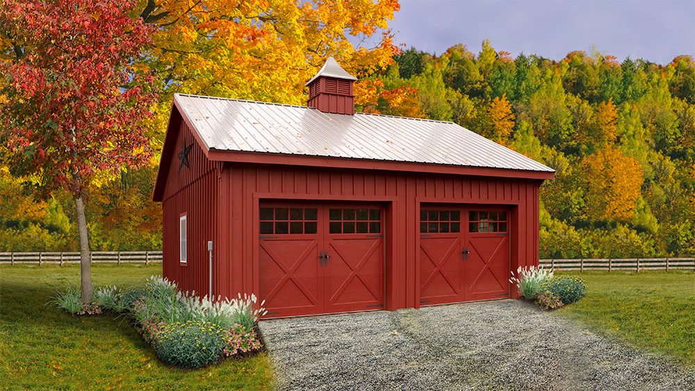 a red barn with a metal roof and a cupola on top. 