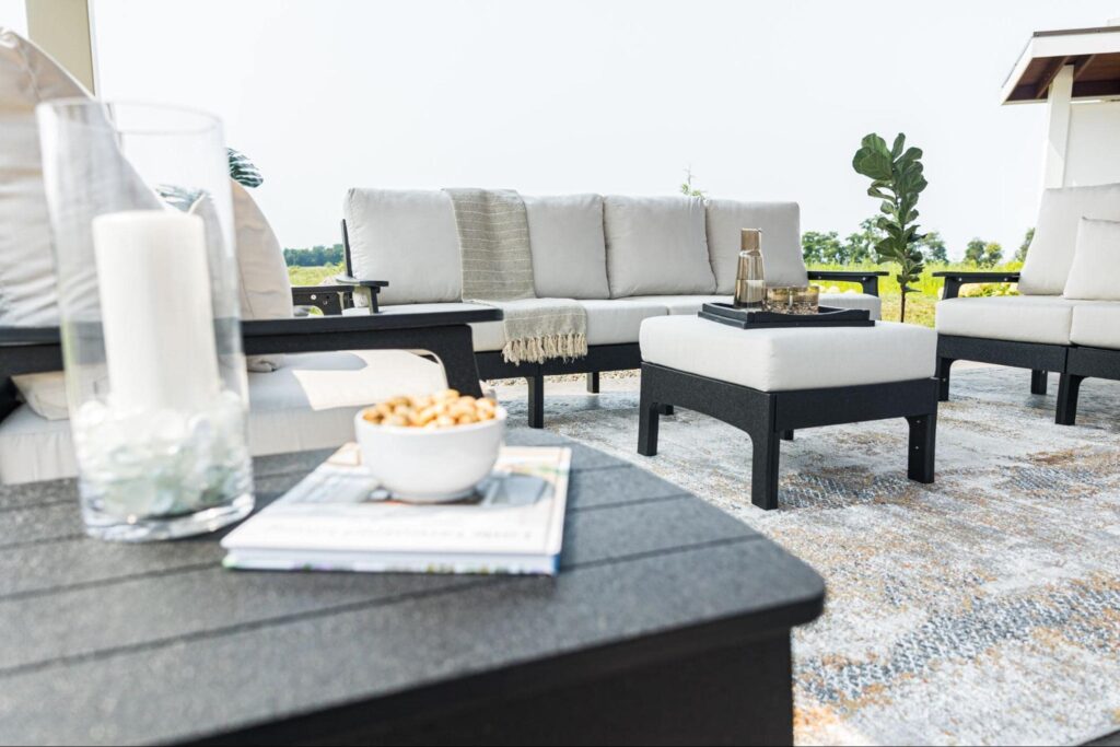 white patio furniture with a bench, small coffee table, and ottoman. 