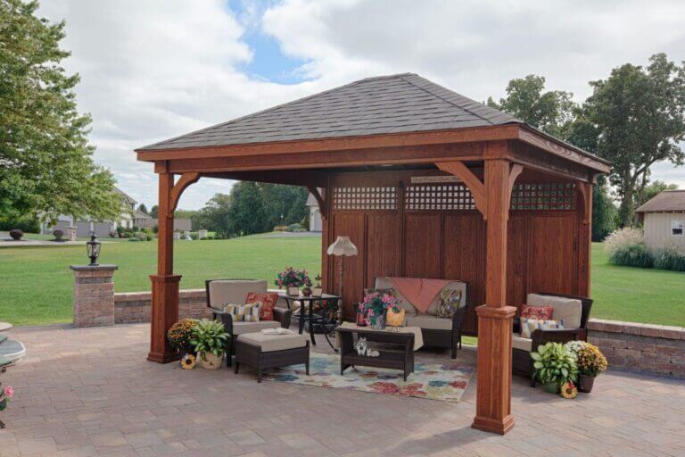 Wooden pavilion on a patio with a privacy wall