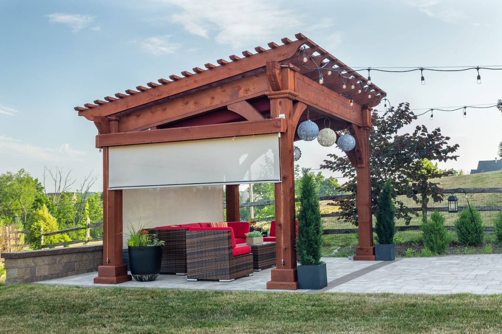 Wooden pergola with a privacy screen pulled down