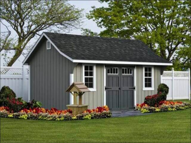 Gray cape elite shed with flowers out front