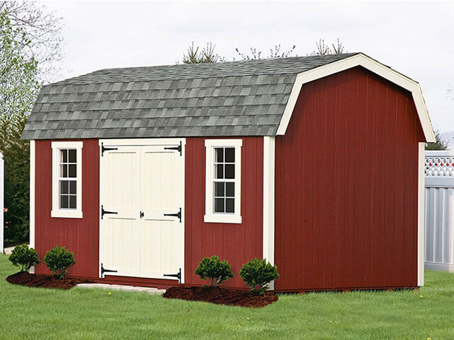 Red Dutch barn style shed in a yard