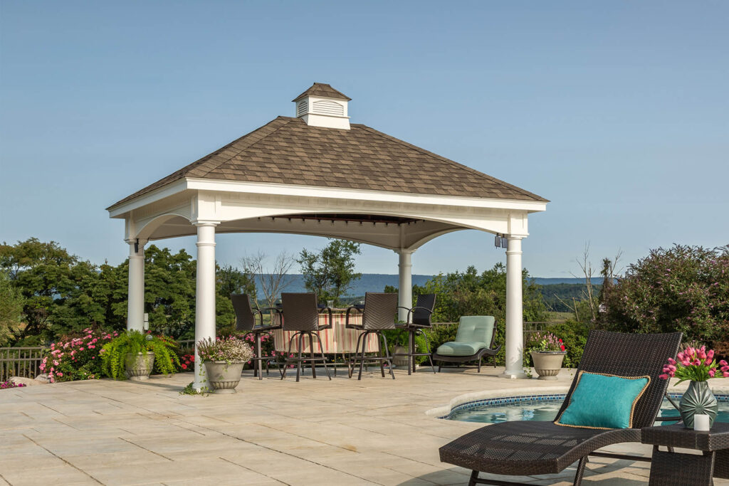 White vinyl pavilion providing a patio roof with outdoor seating beneath
