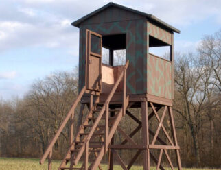 6’x6’ square Amish built deer blind with a 10' tower, staircase with a railing, and open windows.