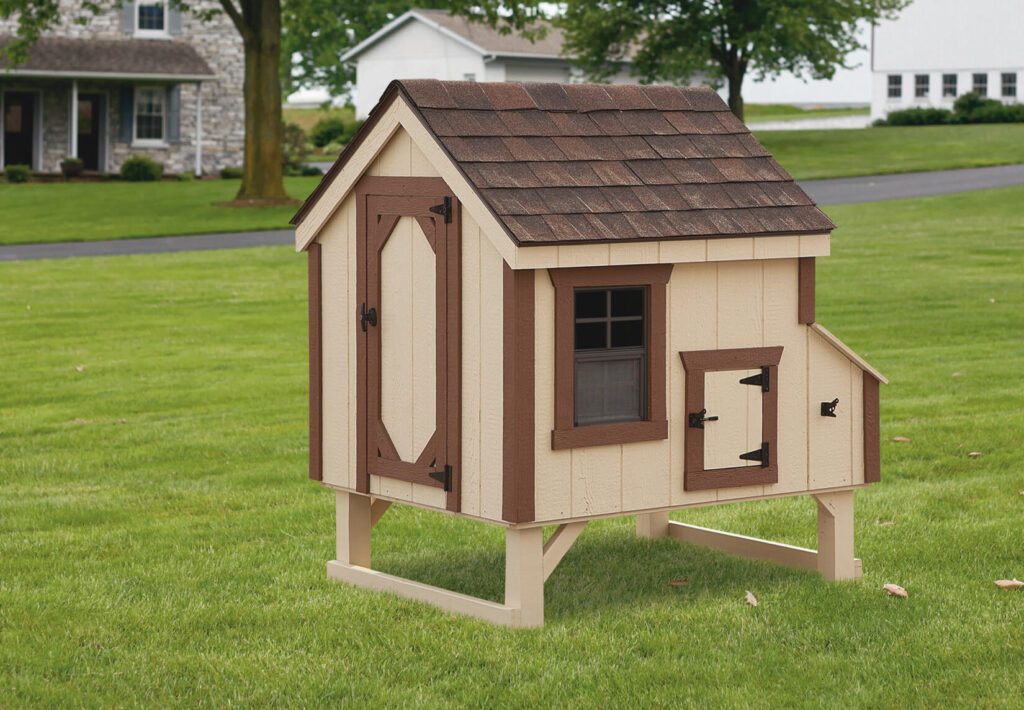 Tan A-frame chicken coop for sale in a yard