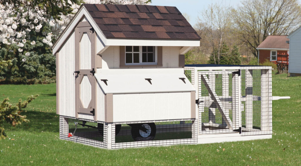 White chicken coop for sale in a yard