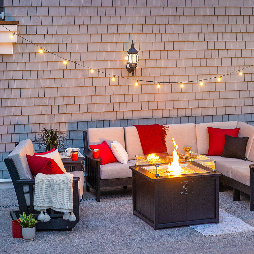 A conversation set of patio furniture around a firepit