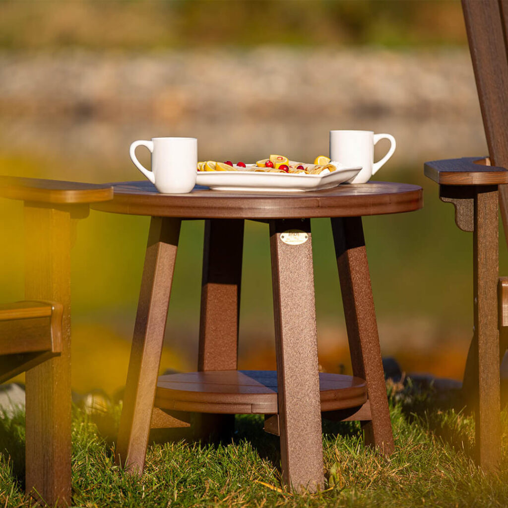 A wooden side table with two mugs and a plate of food on it