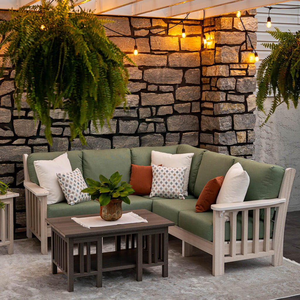 A patio furniture sofa with green cushions