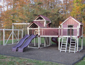 Tan and red vinyl swing set with multiple towers, swings, and slides