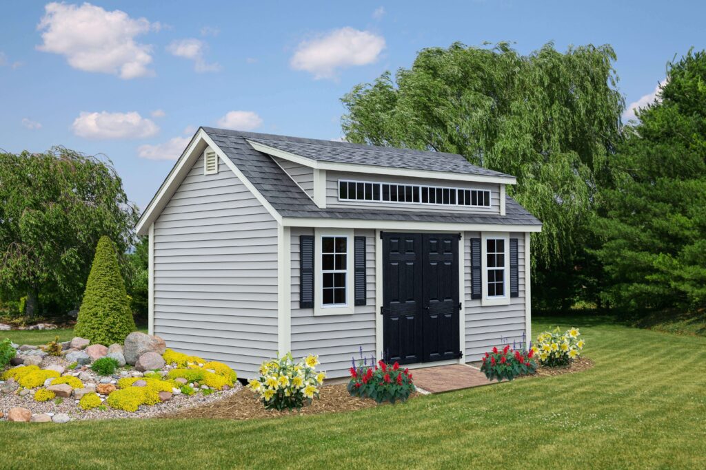 Gray shed with a black door in a yard