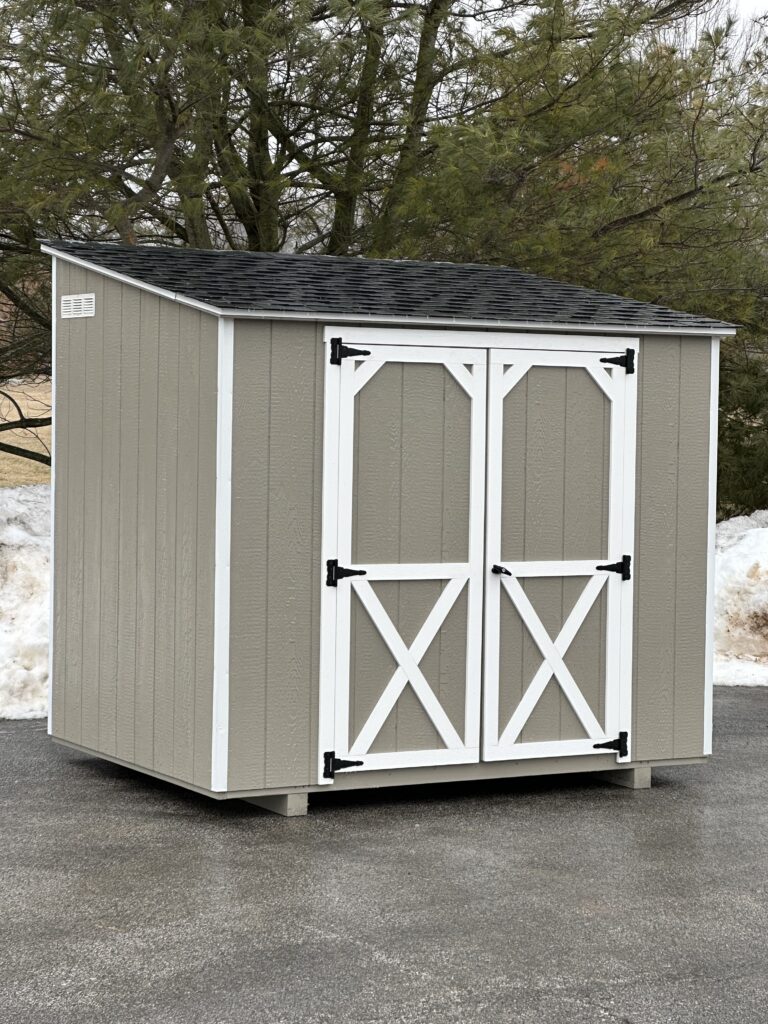 In stock, mini lean to beige and white trim shed