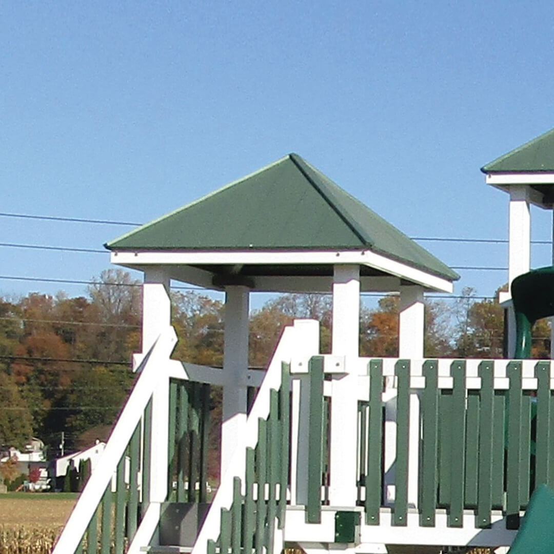 Green hipped roof on a white swing set