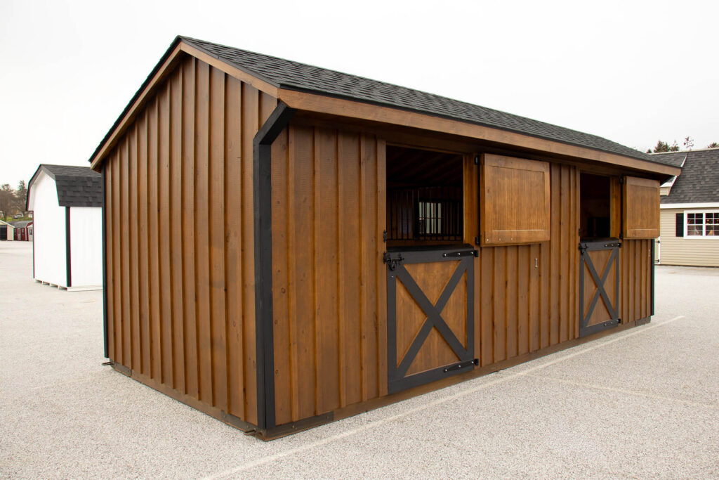 Brown, wooden, in-stock shed row barn for sale on the Penn Dutch Structures lot in Shrewsbury, PA